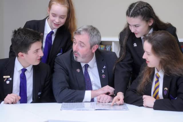 Pictured are pupils Joseph McGuinness, 13, Rebecca Fuller, 12, Lucy-Mae Cheatle, 13 and Kaja Baran, 15 with new headteacher John Woods.