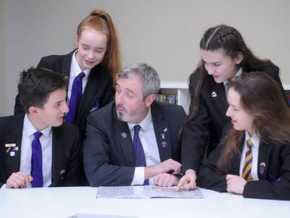 Pictured are pupils Joseph McGuinness, 13, Rebecca Fuller, 12, Lucy-Mae Cheatle, 13 and Kaja Baran, 15 with new headteacher John Woods.
