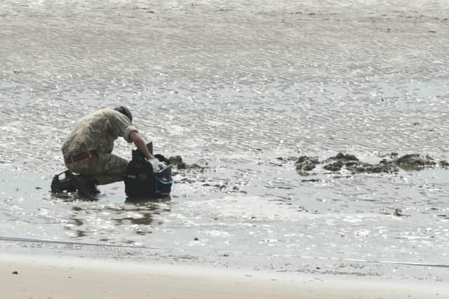 A military expert examining the device