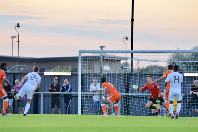 Nathan Delfouneso stoops to head home Blackpool's opener