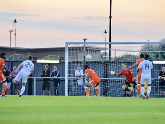 Nathan Delfouneso stoops to head home Blackpool's opener