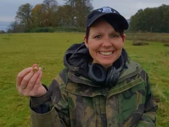 Michelle Vall with the ring she found while metal-detecting