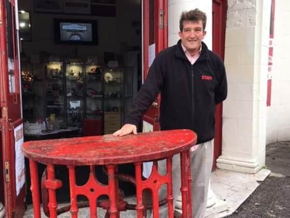 Olly Ashton, auctioneer at Regent Auctions with the turnstile