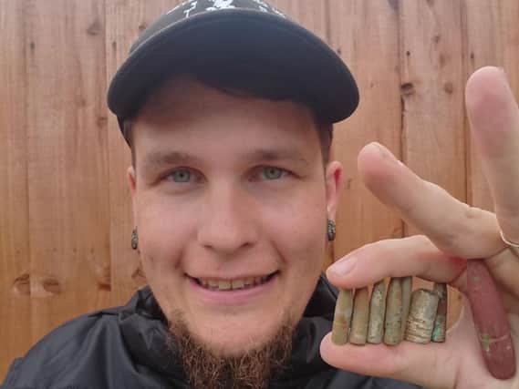 Luke and the bullets he discovered in the sand on Monday.