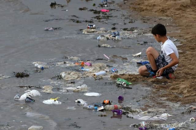 Taken by Gazette photographer Dan Martino, the picture shows a young boy surrounded by a tide of rubbish