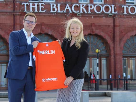 Ben Hatton of Blackpool FC and Kate Shane from Merlin celebrate the new sponsorship