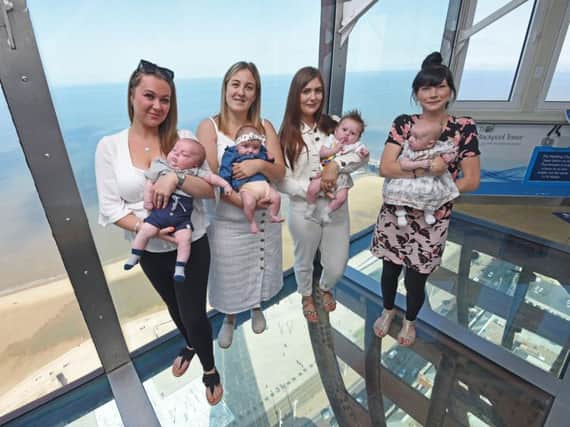 The lucky tots with their mums at the top of the Tower