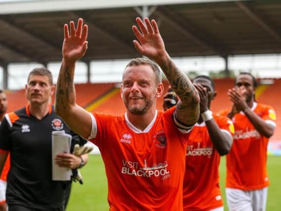 Captain and goalscorer Jay Spearing leads the Blackpool celebrations after the final whistle