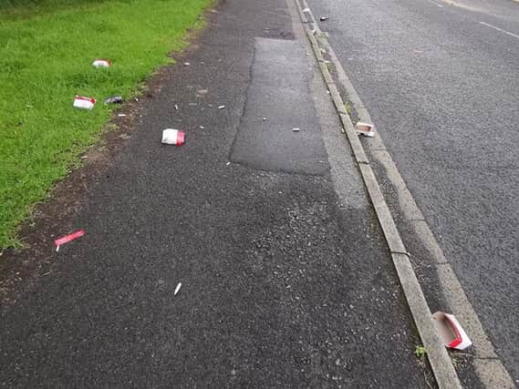 Boxes of canisters littered the pavement on Heys Street. Credit: Richard Walmsley