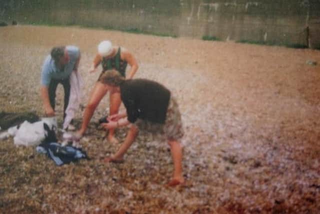 Julie getting covered with grease to insulate her against the cold of the Channel water. With mum Isobel and dad Philip