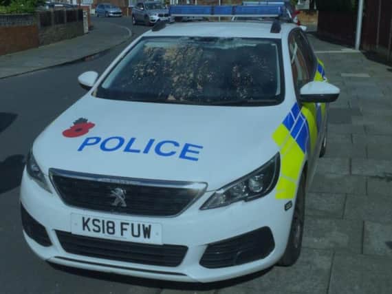 A 29-year-old man has been charged with criminal damage after climbing onto a police car in Blackpool and causing damage to the roof and window