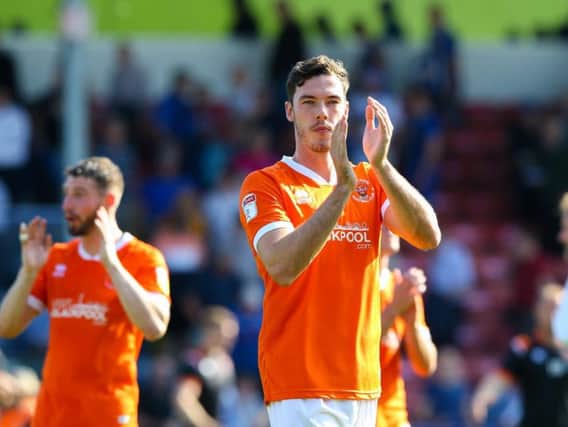 Ben Heneghan applauds the Blackpool fans after his cameo comeback at Rochdale