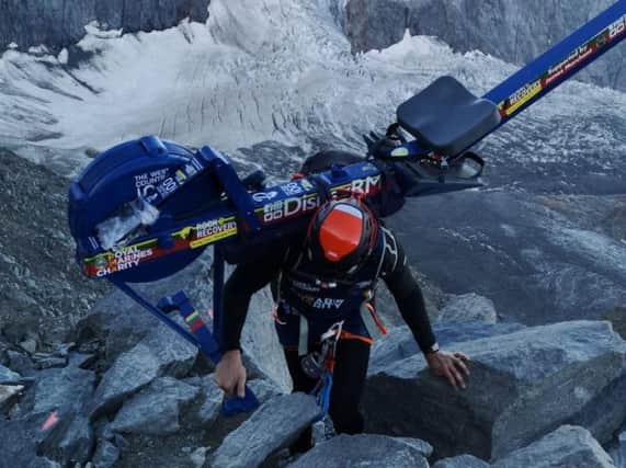 Matthew Disney climbing Mont Blanc carrying his rowing machine