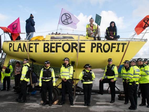 Police form a cordon in front of the Extinction Rebellion protest at the Preston New Road fracking site