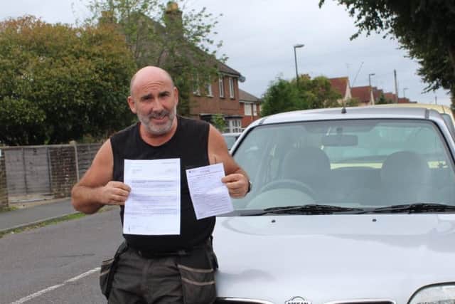 Barry King with his fine and MOT in front of his Micra