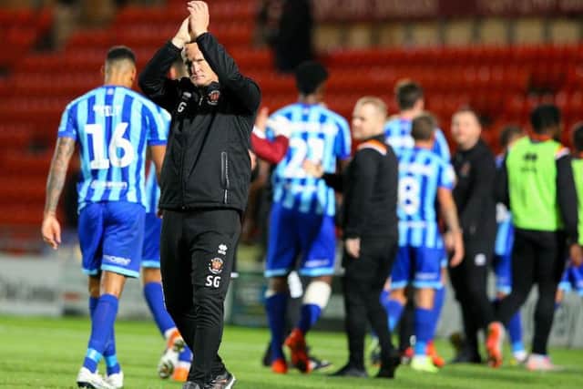 Simon Grayson applauds the Pool fans at full time