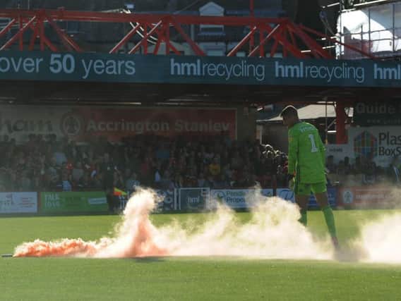 A flare was thrown on to the pitch during Blackpool's League One game at Accrington Stanley