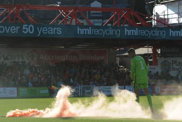 A flare was thrown on to the pitch during Blackpool's League One game at Accrington Stanley