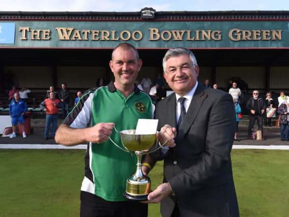 Paul Dale receives the Waterloo trophy from former world snooker champion John Parrott