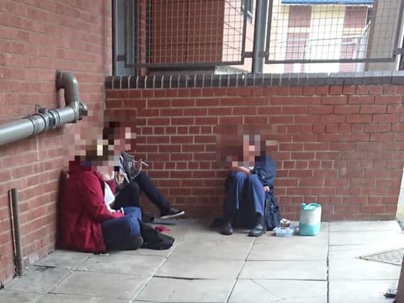 Three people dressed in NHS uniforms - with their coats over the top - were pictured smoking in an alleyway near to the maternity unit at Blackpool Victoria Hospital, which bans lighting up anywhere on its premises and even sends specialist advisers to speak to poorly patients during their stay in a bid to get them to give up their own habit