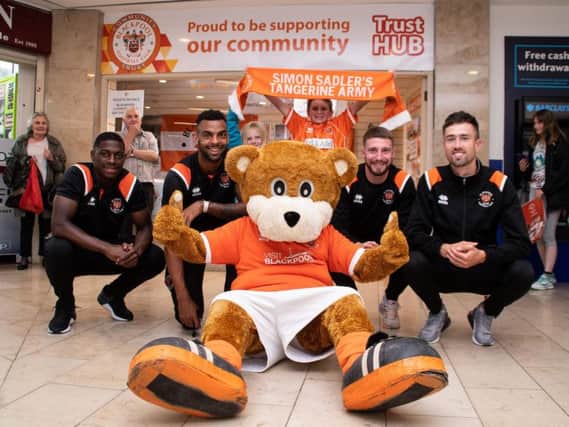 Sullay Kaiai, Curtis Tilt, James Husband and Ryan Hardie outside the new Blackpool FC store in August.