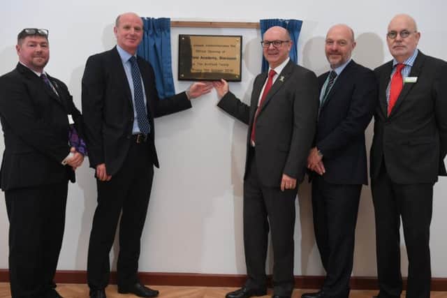Duncan and John Armfield unveil the plaque at Armfield Academy as the school had its official opening