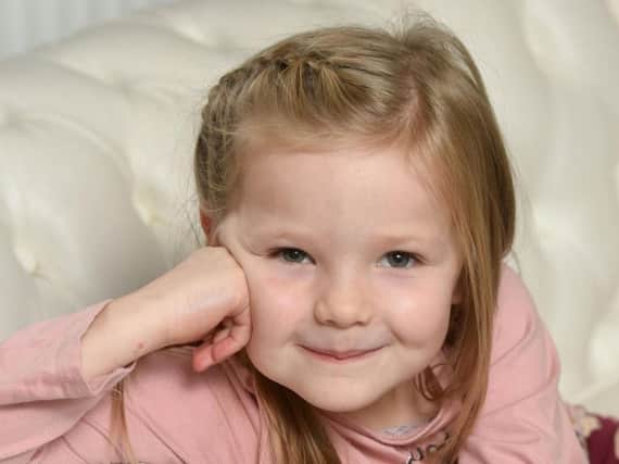Six year old Hollie Heywood helped draw attention to a man having a heart attack outside the Briardene Hotel