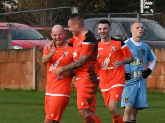 AFC Blackpool congratulate Jamie Milligan (left) on his spectacular long-range goal against Bacup   Picture: ADAM GEE
