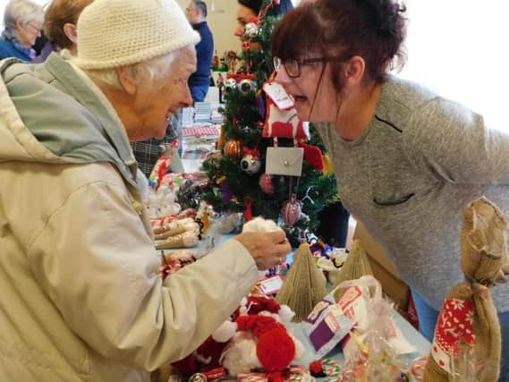 Care worker and craft stylist Jenny Wilson, of the Princess Alexandra Home, chats to a visitor at last years Christmas Fair