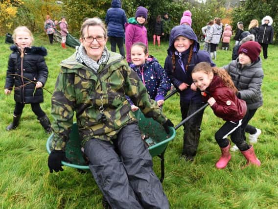 Teacher Kate Steventon is pushed to the woods by pupils at Northfold Community Primary school.