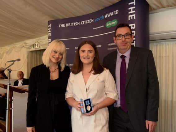 Ellie Toth is presented with her British Citizen Youth  Award, with celebrity guest host Kimberley Wyatt (left)