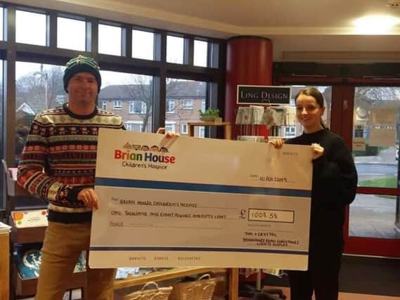 Tim Holloway presents his cheque for 1008.58 to Brian House after his 2018 Christmas lights switch-on.