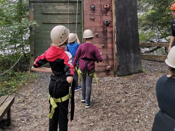Pupils from Aspire Academy tackle the climbing wall during a trip to the Lakes
