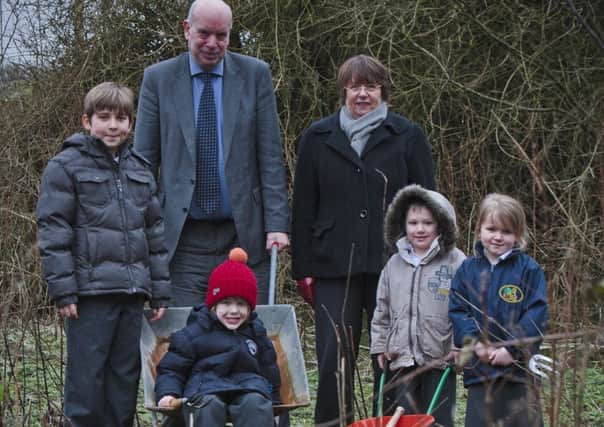 DIGGING DEEP:  Youngsters at Gisburn Primary School with David Ingham and Jackie Clements.