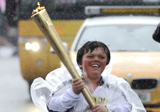 St Annes teenager Ben Holmes carrying the Olympic torch through Fleetwood