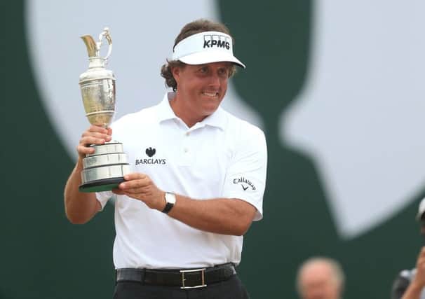 Phil Mickelson celebrates with the Claret Jug after winning the 2013 Open Championship at Muirfield Golf Club, East Lothian.