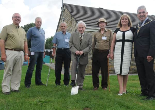 John O'Toole reneacts the sod cutting ceremony at the North Holme estate during the exhibition at the community centre watched by Bob Abel, Steve Marshall, Ken Ranson, Peter Dawson, Deputy Mayoress Joanna Sagar and Deputy Mayor Graham Roach.