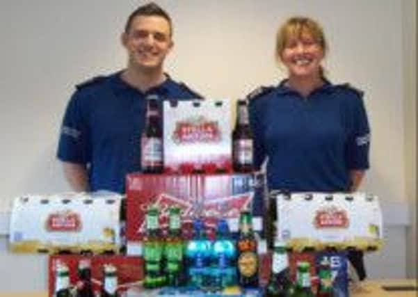 Kirkham PCSOs Sterling and Marwick with a collection of alcohol confiscated from youths on Fyldes streets and parks.