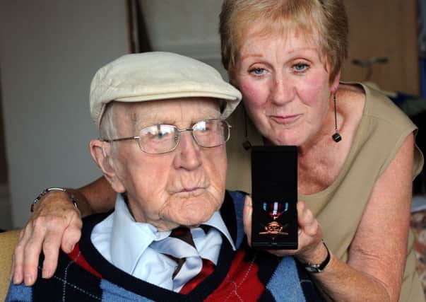 Wilfred Robertson has been awarded the Arctic Star for his efforts in the Arctic convoys of the Second World War (below). He is pictured with daughter Estelle Drummond.