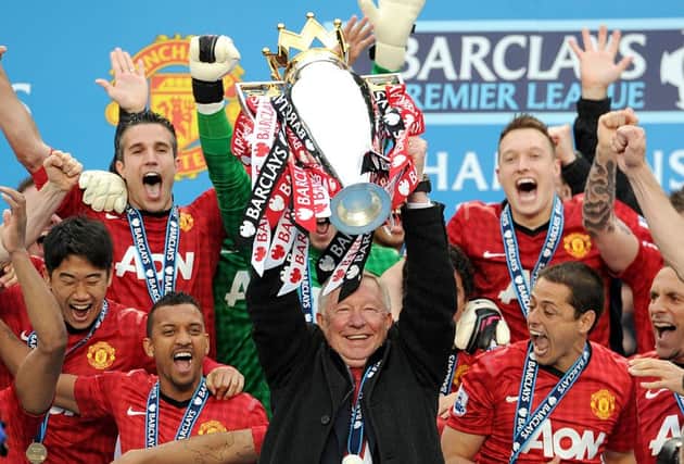 Manchester United manager Sir Alex Ferguson lifting the Barclays Premier League trophy.