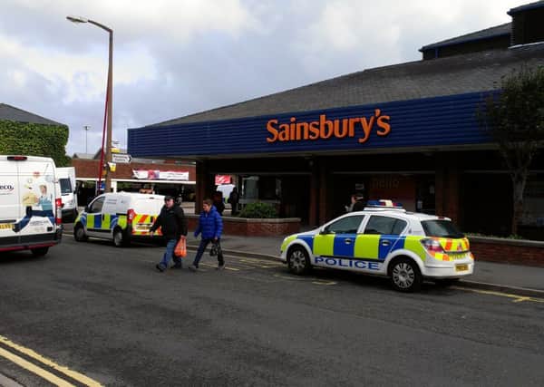Police at the scene of the robbery at Sainsbury's, St Annes.