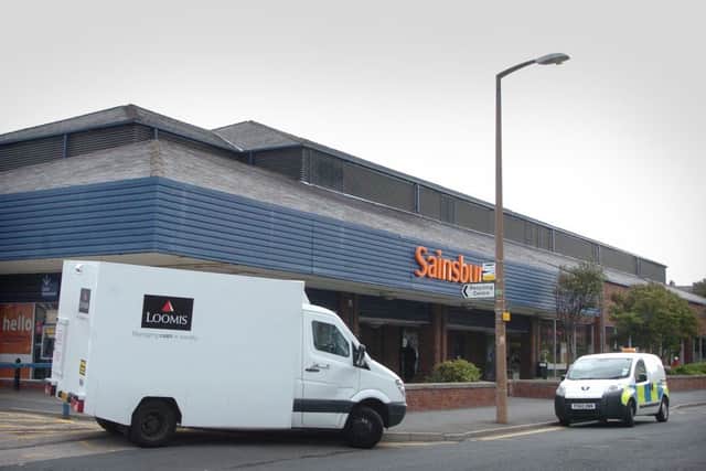 Thieves got away with a quantity of cash following an armed robbery at the St Annes Sainsbury's supermarket.. The security van and police at the scene.