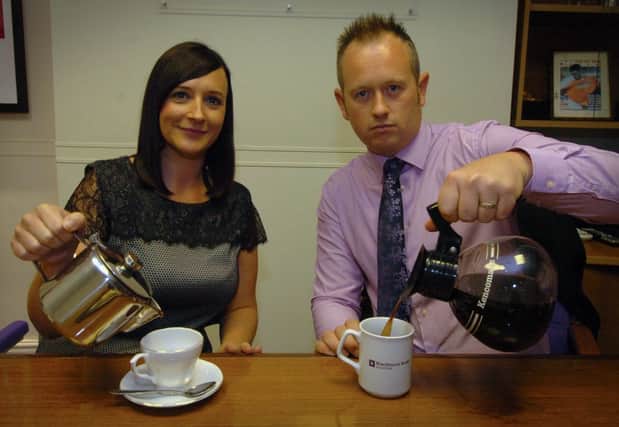 Staff at Blackpool solicitors Blackhurst Budd pose for a picture to illustrate the findings of a recent survey, which concludes that tea drinkers are happier in the office than those that drink coffee. Cheerful tea drinker Carrie Ball and a rather more dour caffeine addict Dominic Haley.