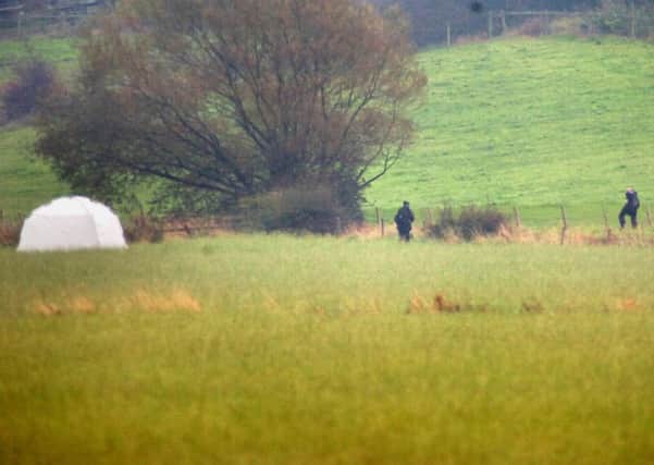 Police in fields close to Spen Brook where the baby was found two years ago this week