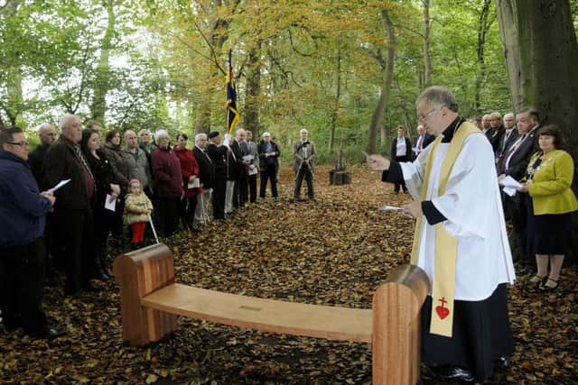Father David Lyon blesses the bench.