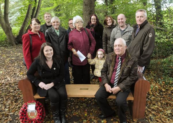 A bench in memory of Sgt Nigel Coupe (below) is unveiled in Witch Wood. Widow Natalie Coupe is pictured with the family. Bottom: Father David Lyon blesses the bench.