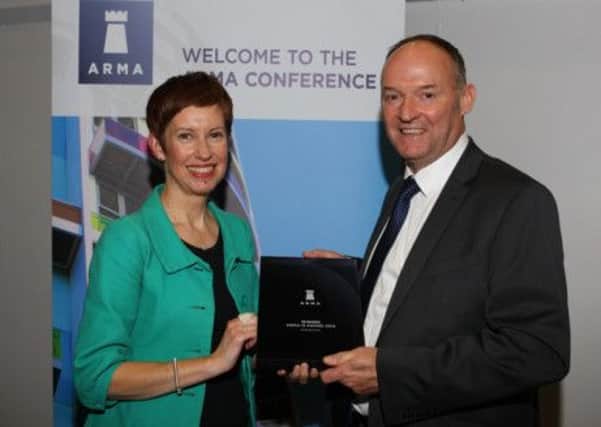 Saturday Breakfasts Sarah Pennells presents the ARMA-Q award to Homestead managing director David Bentham.