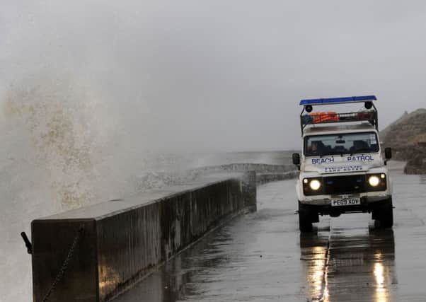 Large waves crash against the sea wall in Blackpool.