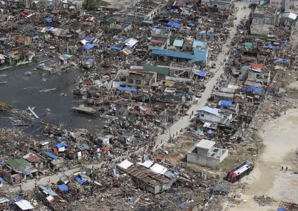 Devastation left by the typhoon in the Philippines. Below: Richard Villarino.
