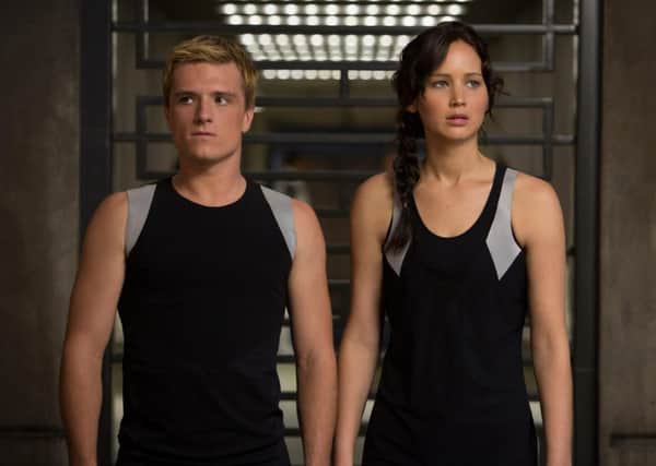 The Hunger Games: Catching Fire. Pictured: Jennifer Lawrence (as Katniss Everdeen) and Josh  Hutcherson (as Peeta Mellark).